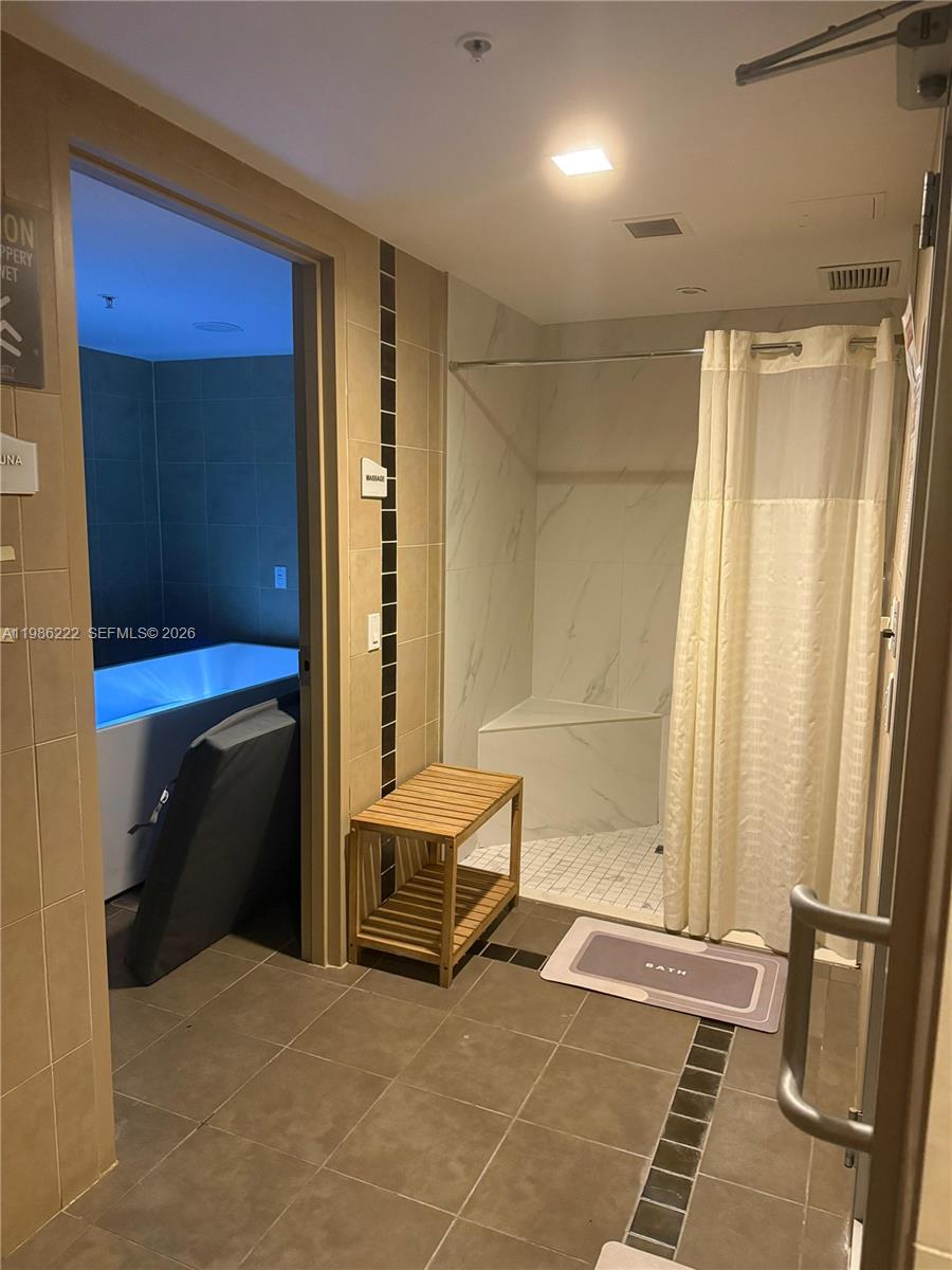 60 Southwest 13th Street, Unit 3017 Miami, FL 33130 - Photo 38 of 46 a view of front door with a furniture and a shower