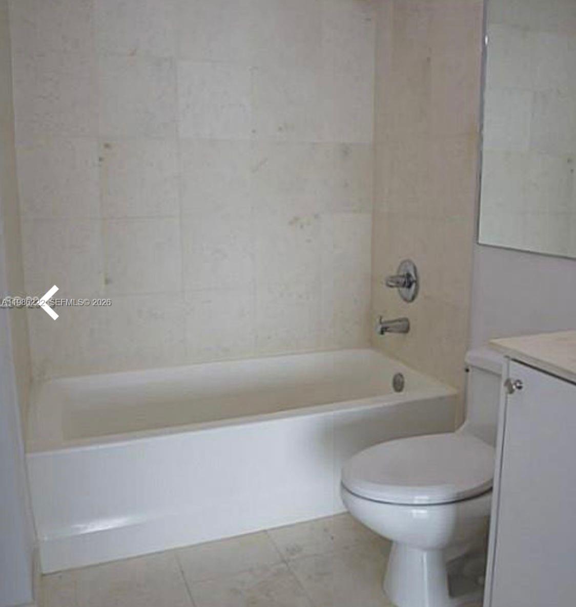 60 Southwest 13th Street, Unit 3017 Miami, FL 33130 - Photo 4 of 46 a bathroom with a bathtub and toilet