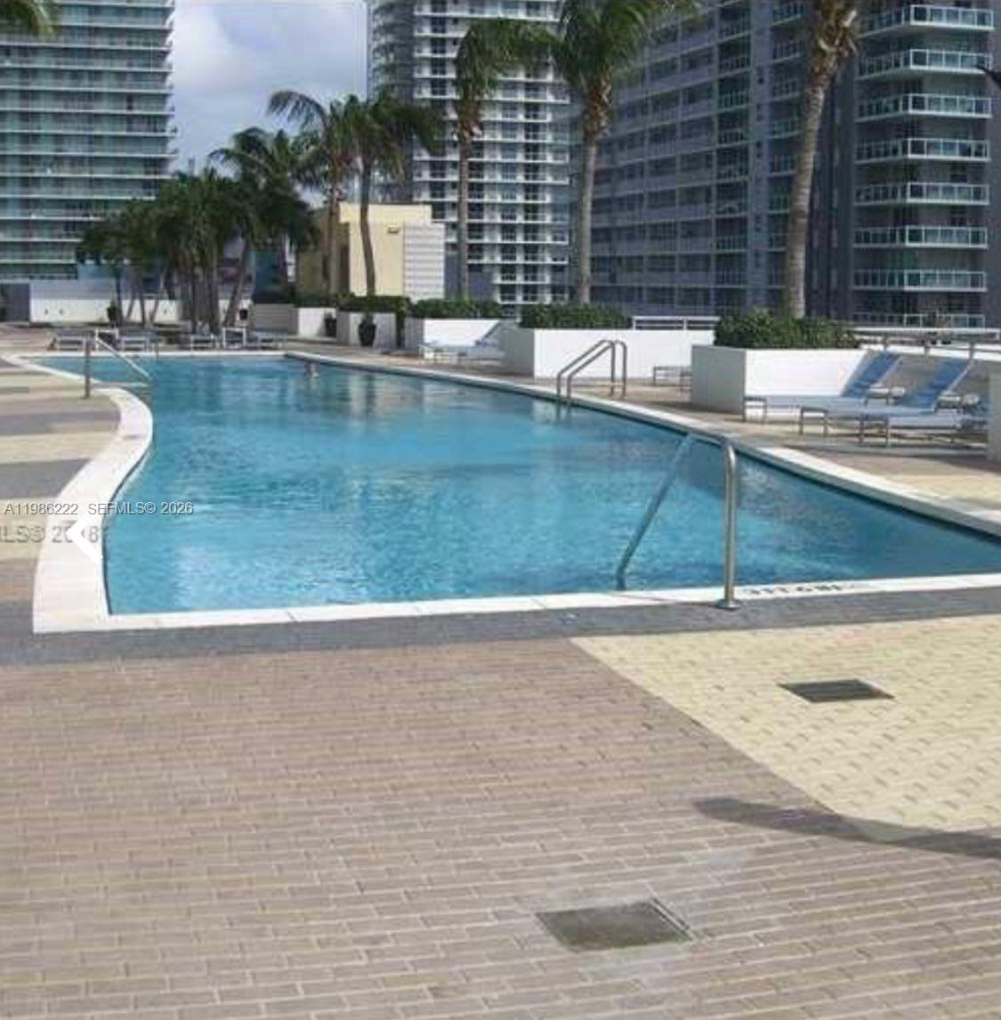 60 Southwest 13th Street, Unit 3017 Miami, FL 33130 - Photo 41 of 46 a view of a swimming pool with a lounge chair