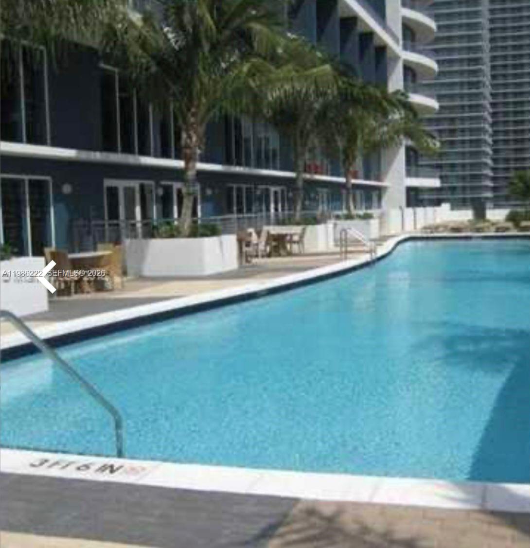 60 Southwest 13th Street, Unit 3017 Miami, FL 33130 - Photo 43 of 46 a view of a swimming pool with a patio