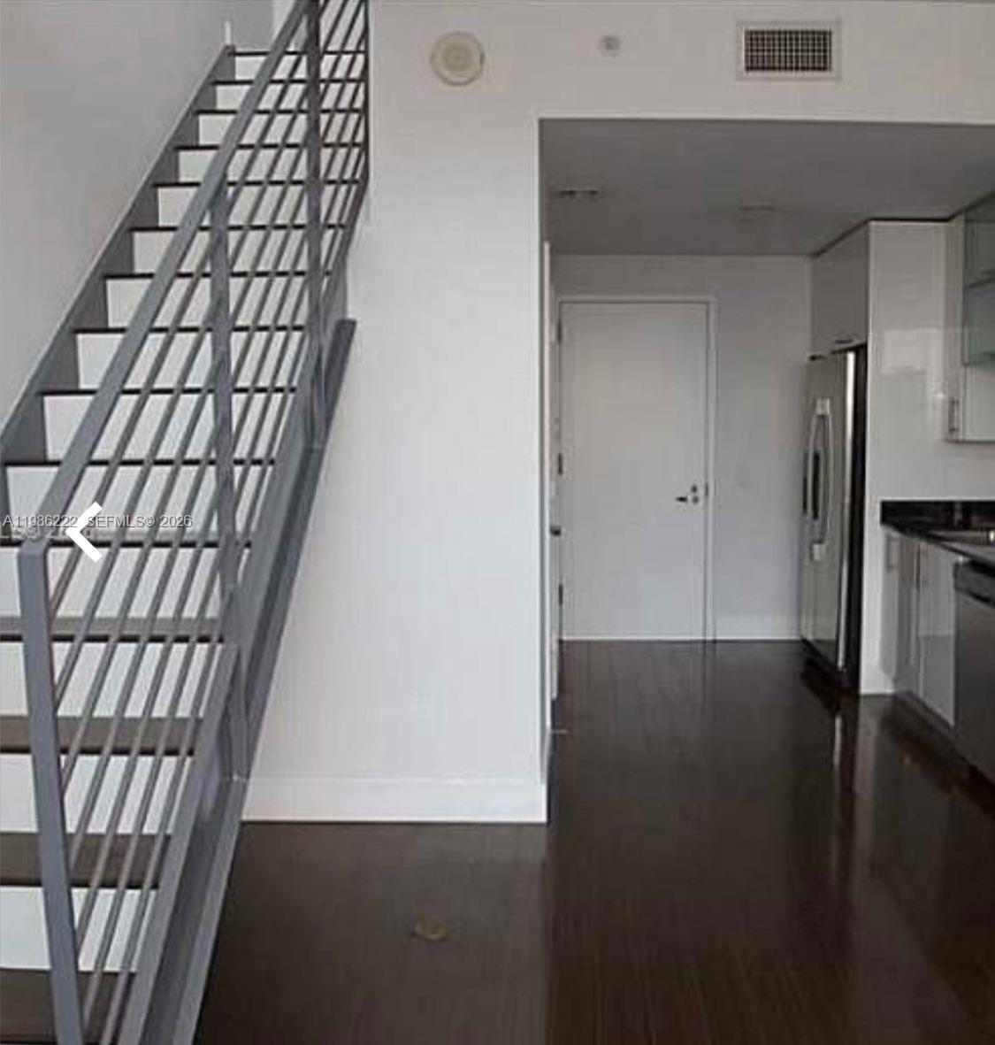 60 Southwest 13th Street, Unit 3017 Miami, FL 33130 - Photo 5 of 46 a view of an empty room with wooden floor and a window