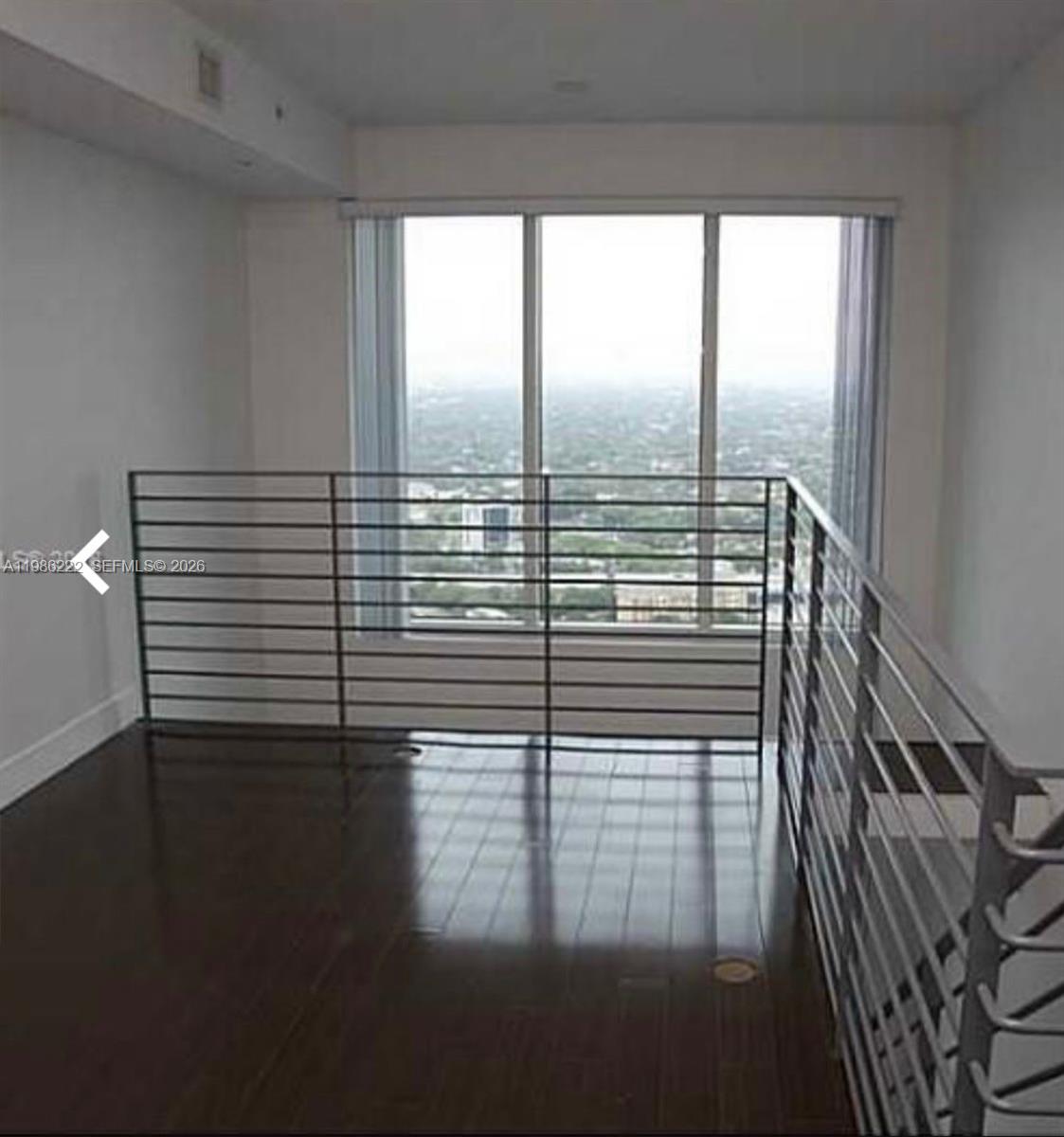 60 Southwest 13th Street, Unit 3017 Miami, FL 33130 - Photo 6 of 46 a view of a room with wooden floor and windows