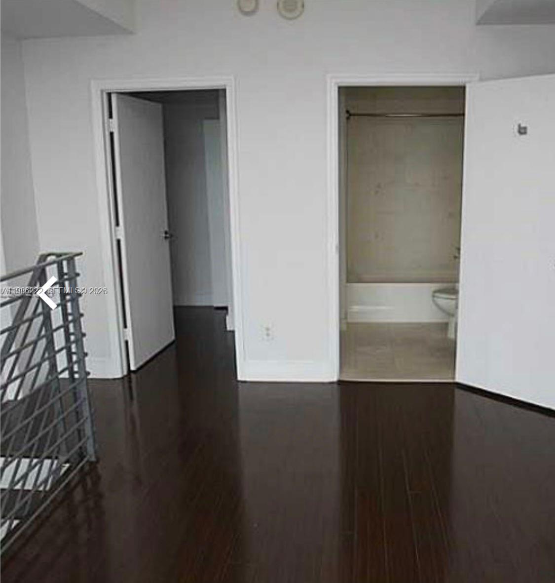 60 Southwest 13th Street, Unit 3017 Miami, FL 33130 - Photo 7 of 46 an empty room with wooden floor and windows