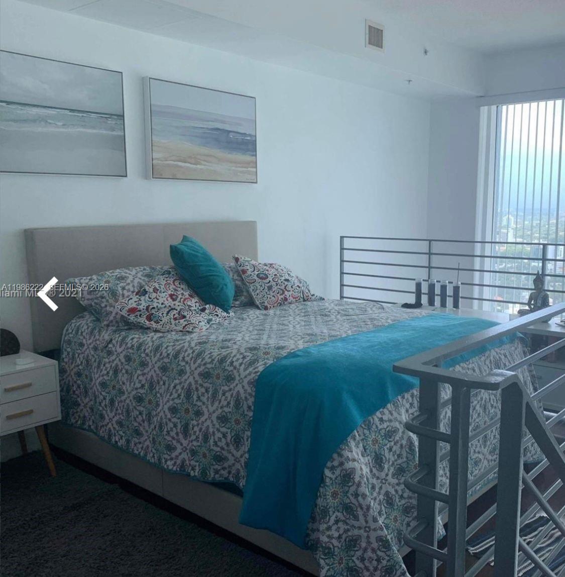 60 Southwest 13th Street, Unit 3017 Miami, FL 33130 - Photo 8 of 46 a bedroom with a bed and a window