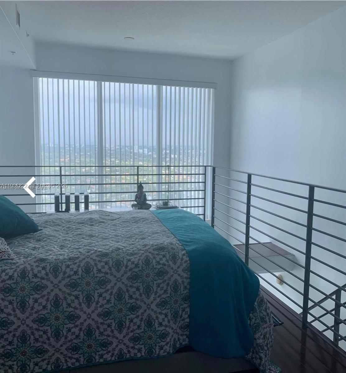 60 Southwest 13th Street, Unit 3017 Miami, FL 33130 - Photo 9 of 46 a bed sitting in a bedroom next to a window