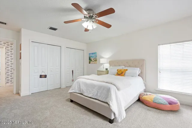 a kitchen with a dining table chairs a stove a microwave and cabinets