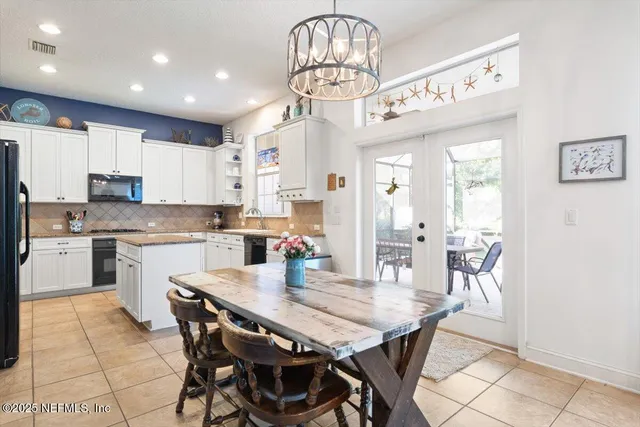 a view of a dining room with furniture large windows and wooden floor