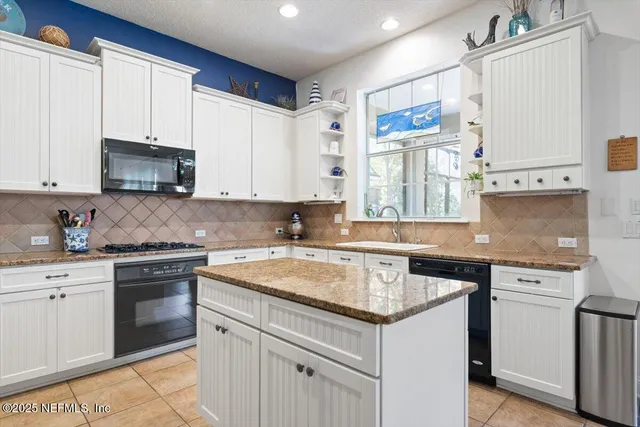 a dining room with furniture a chandelier and a rug