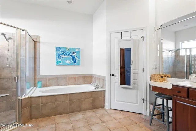 an aerial view of residential houses with outdoor space and trees