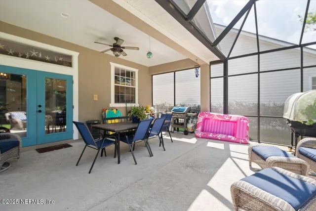 an empty room with wooden floor and large windows