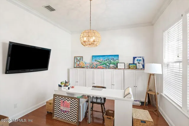 a view of a workspace with furniture and a window