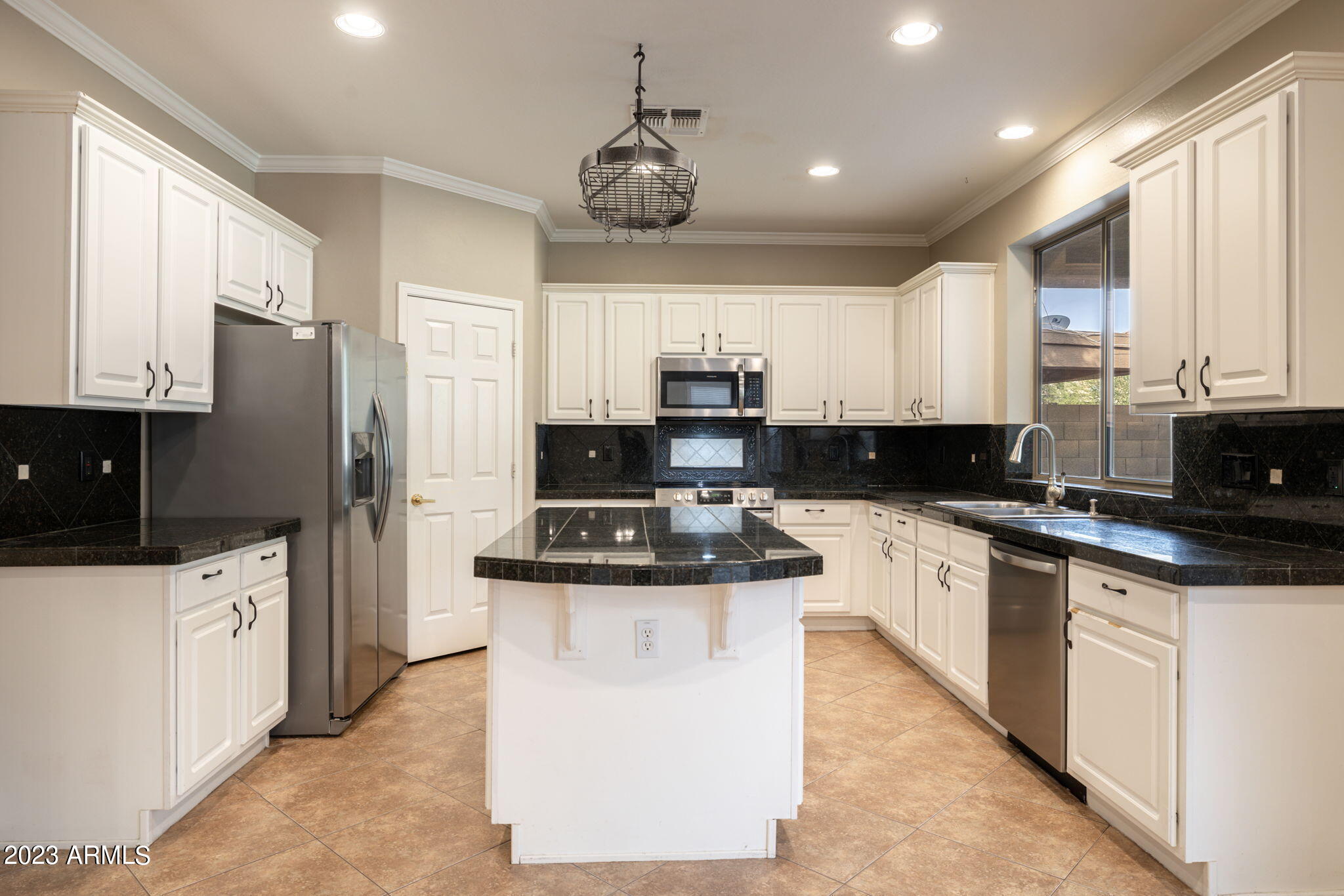 3338 West Hemingway Lane Phoenix, AZ 85086 - Photo 13 of 48 a kitchen with stainless steel appliances granite countertop a stove top oven a refrigerator a sink and dishwasher with white cabinets