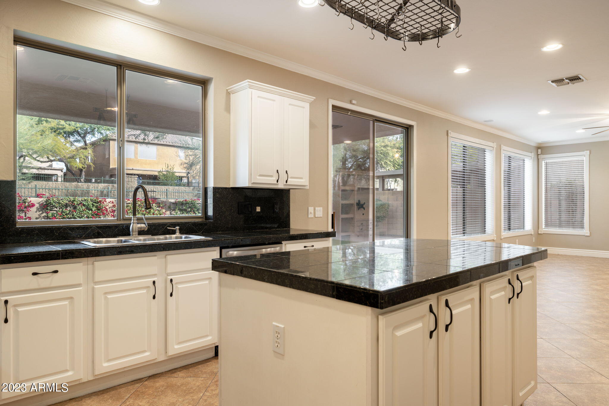 3338 West Hemingway Lane Phoenix, AZ 85086 - Photo 14 of 48 a kitchen with granite countertop a sink and white cabinets