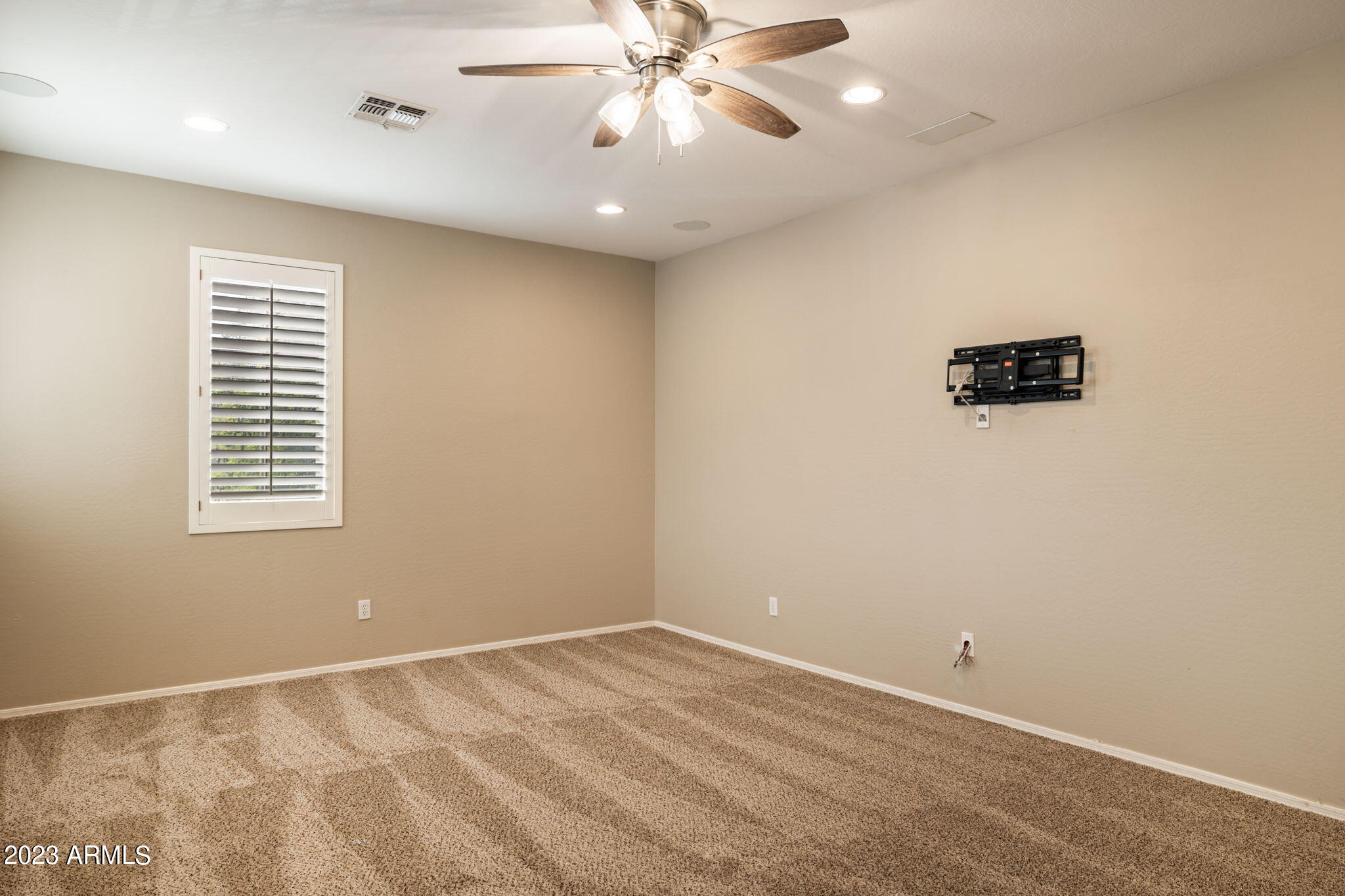 3338 West Hemingway Lane Phoenix, AZ 85086 - Photo 22 of 48 an empty room with a window and a ceiling fan