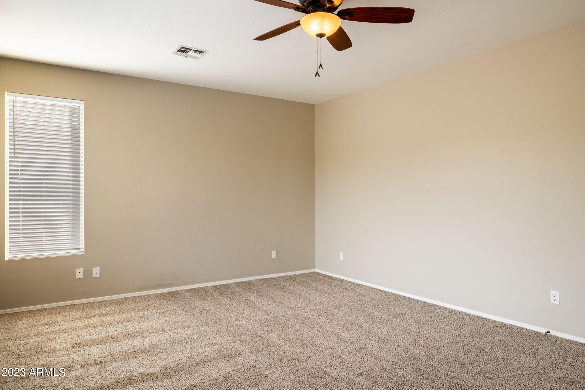 3338 West Hemingway Lane Phoenix, AZ 85086 - Photo 25 of 48 an empty room with a window and a fan