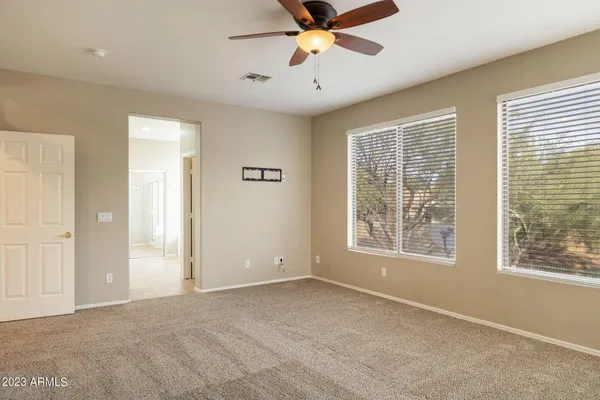 a view of a livingroom with a ceiling fan and window