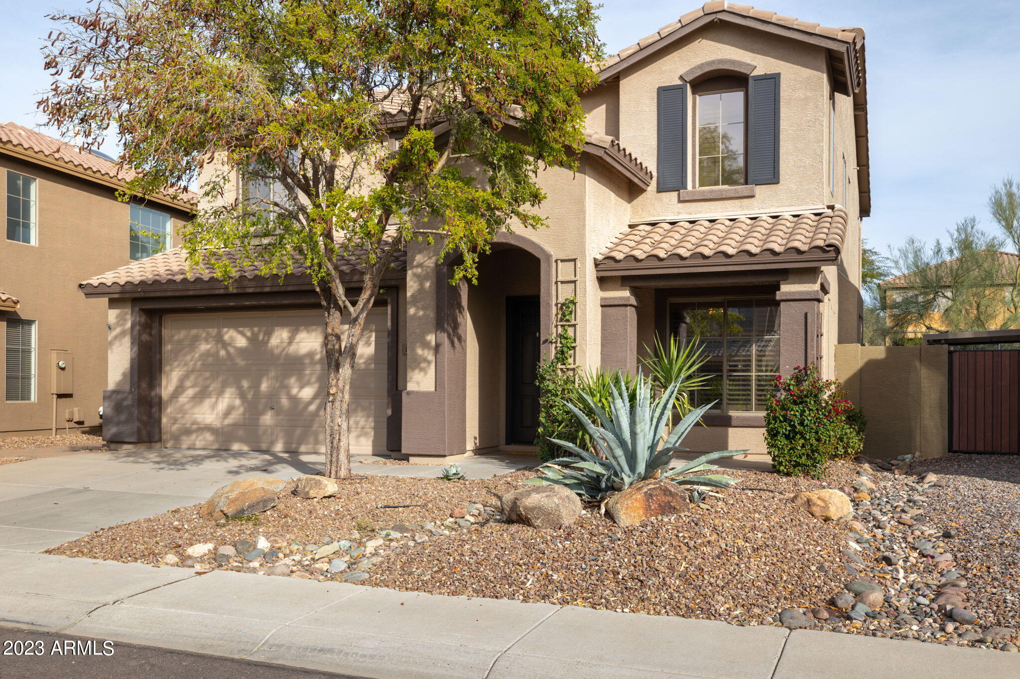 3338 West Hemingway Lane Phoenix, AZ 85086 - Photo 3 of 48 a front view of a house with garden