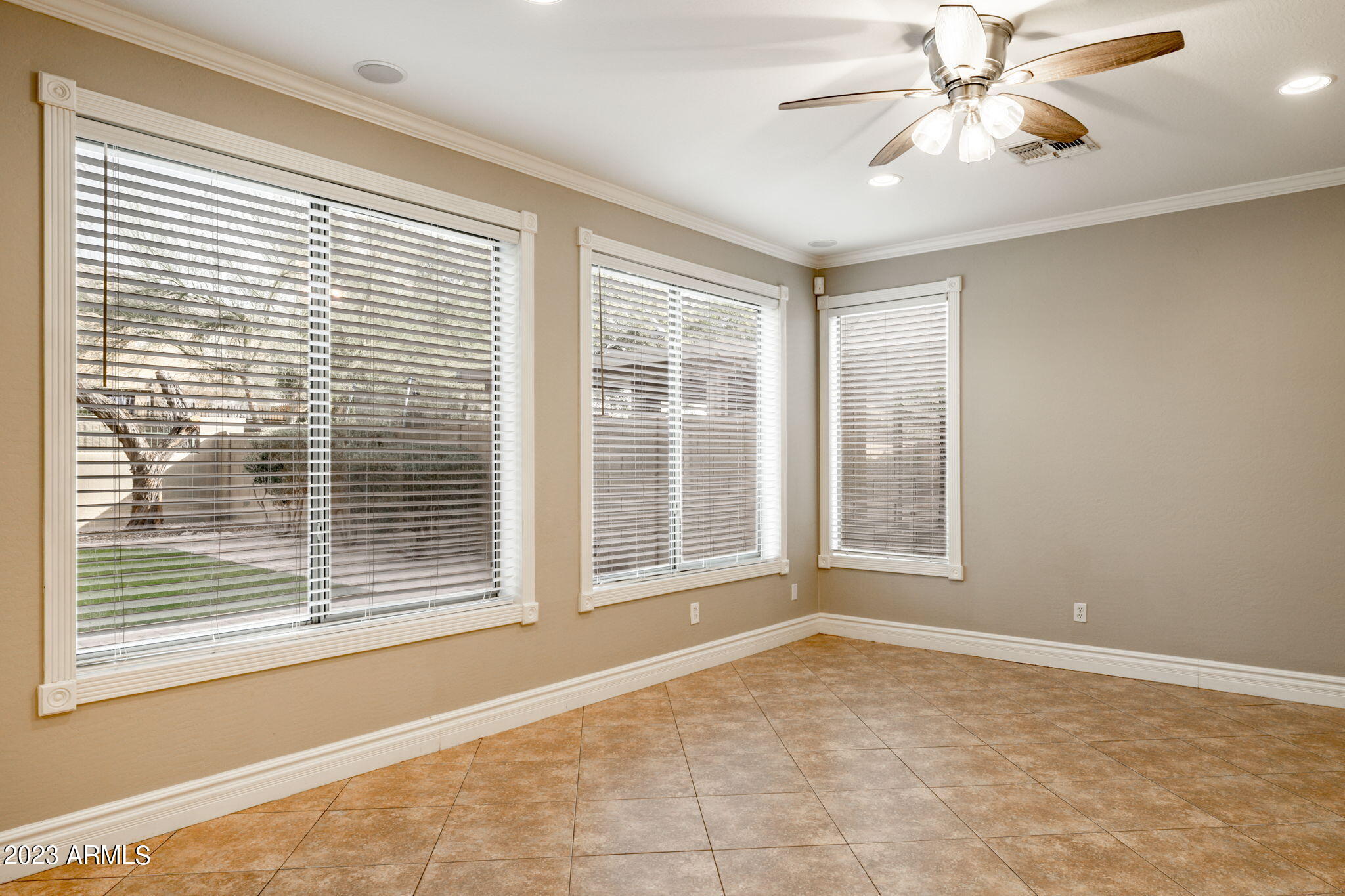 3338 West Hemingway Lane Phoenix, AZ 85086 - Photo 8 of 48 a view of an empty room with a window and a ceiling fan