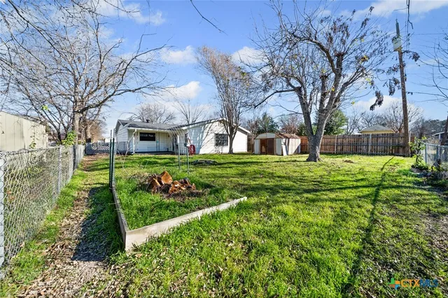 a view of a backyard with large trees
