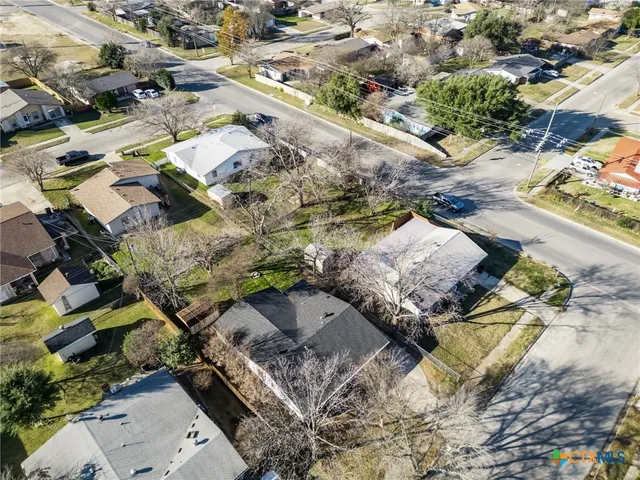 an aerial view of a house with a yard