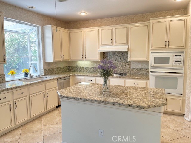 45360 Vista Verde Temecula, CA 92592 - Photo 11 of 23 a kitchen with granite countertop a sink a stove and cabinets