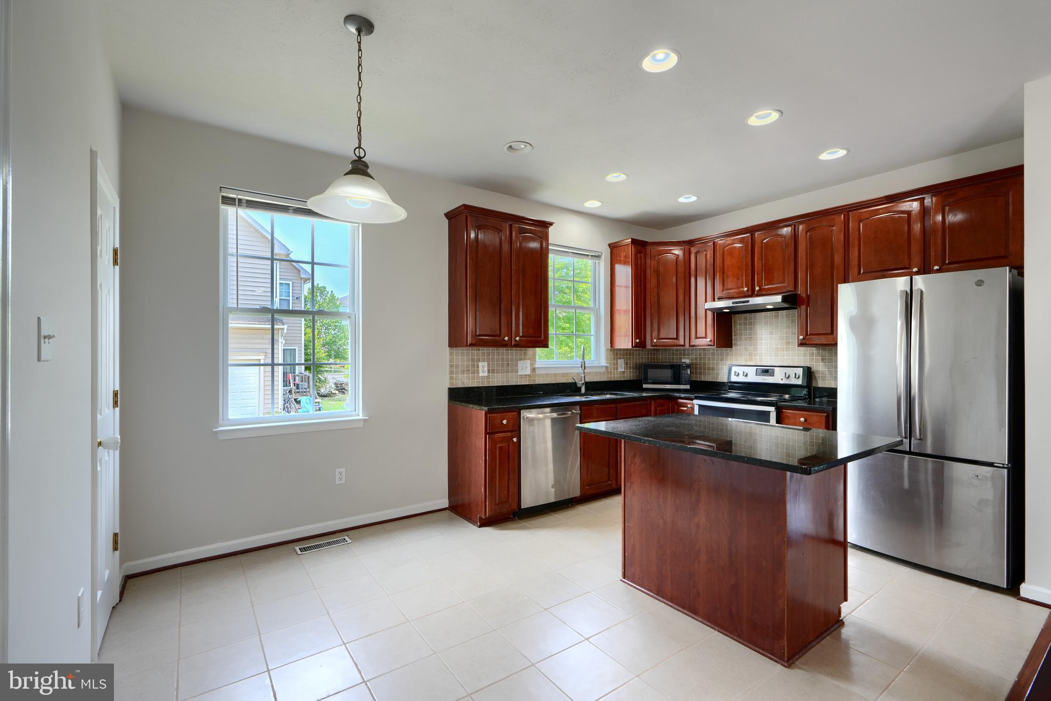 724 Tinker Road Middle River, MD 21220 - Photo 13 of 68 a kitchen with stainless steel appliances granite countertop a refrigerator a sink dishwasher a oven with wooden cabinets
