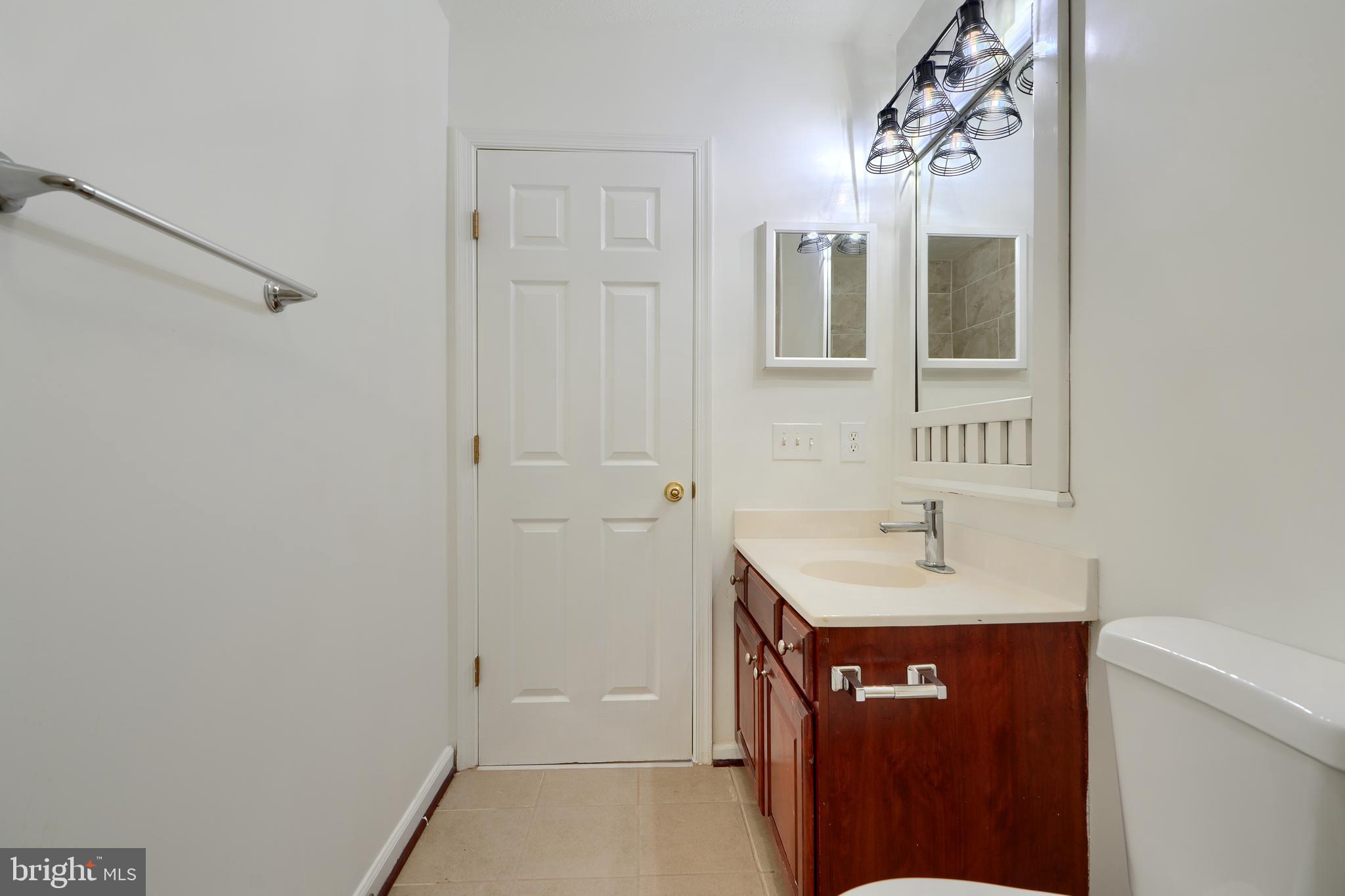 724 Tinker Road Middle River, MD 21220 - Photo 38 of 68 a bathroom with a sink and a mirror