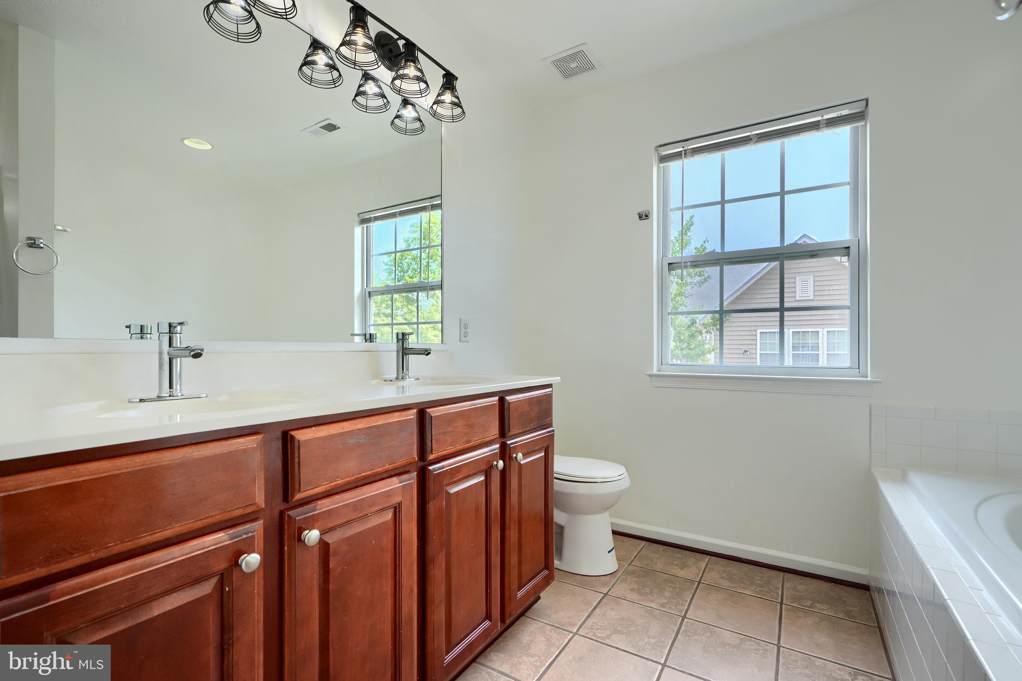 724 Tinker Road Middle River, MD 21220 - Photo 45 of 68 a bathroom with a sink mirror vanity and toilet