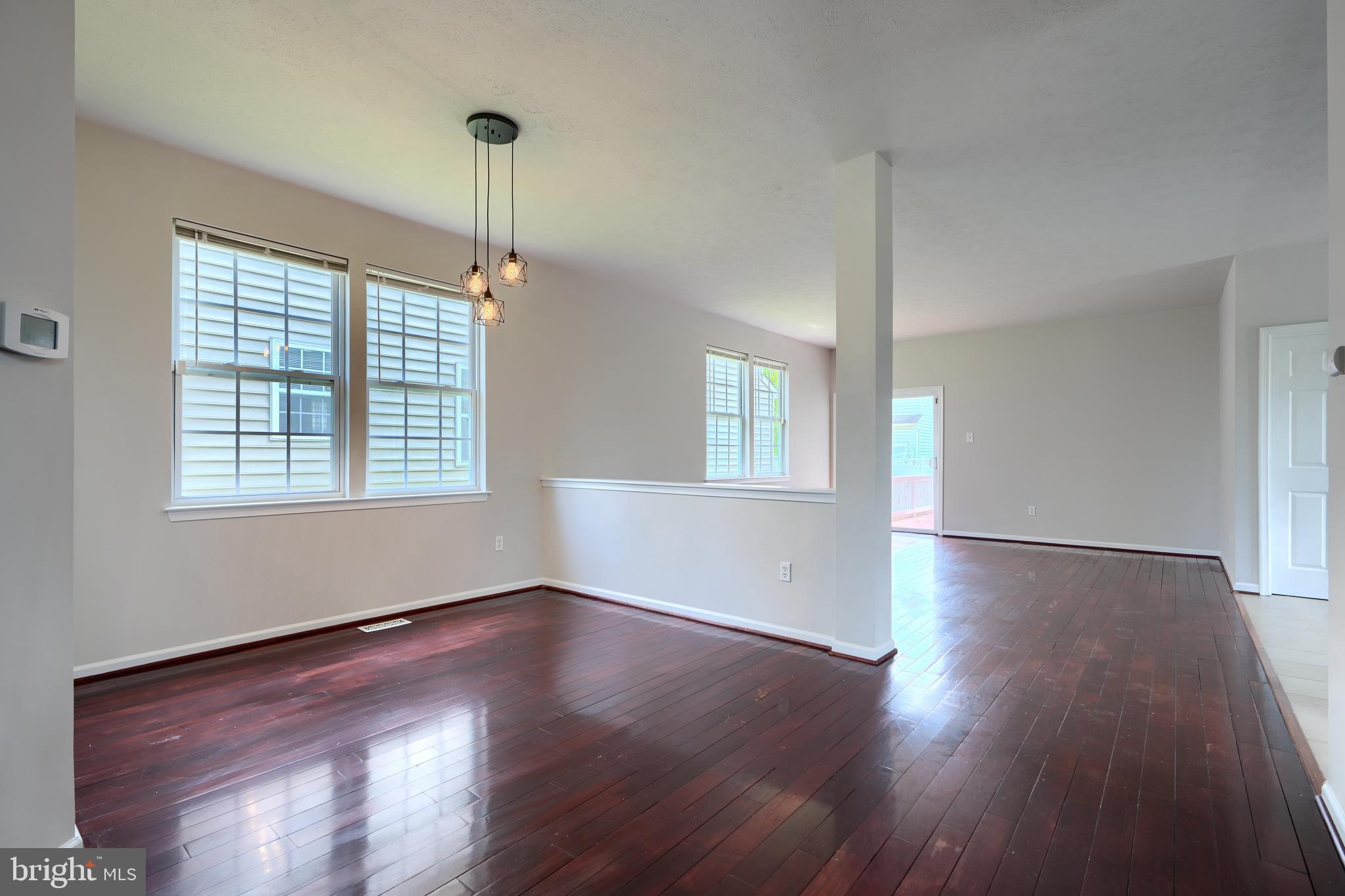 724 Tinker Road Middle River, MD 21220 - Photo 5 of 68 a view of an empty room with wooden floor and a window