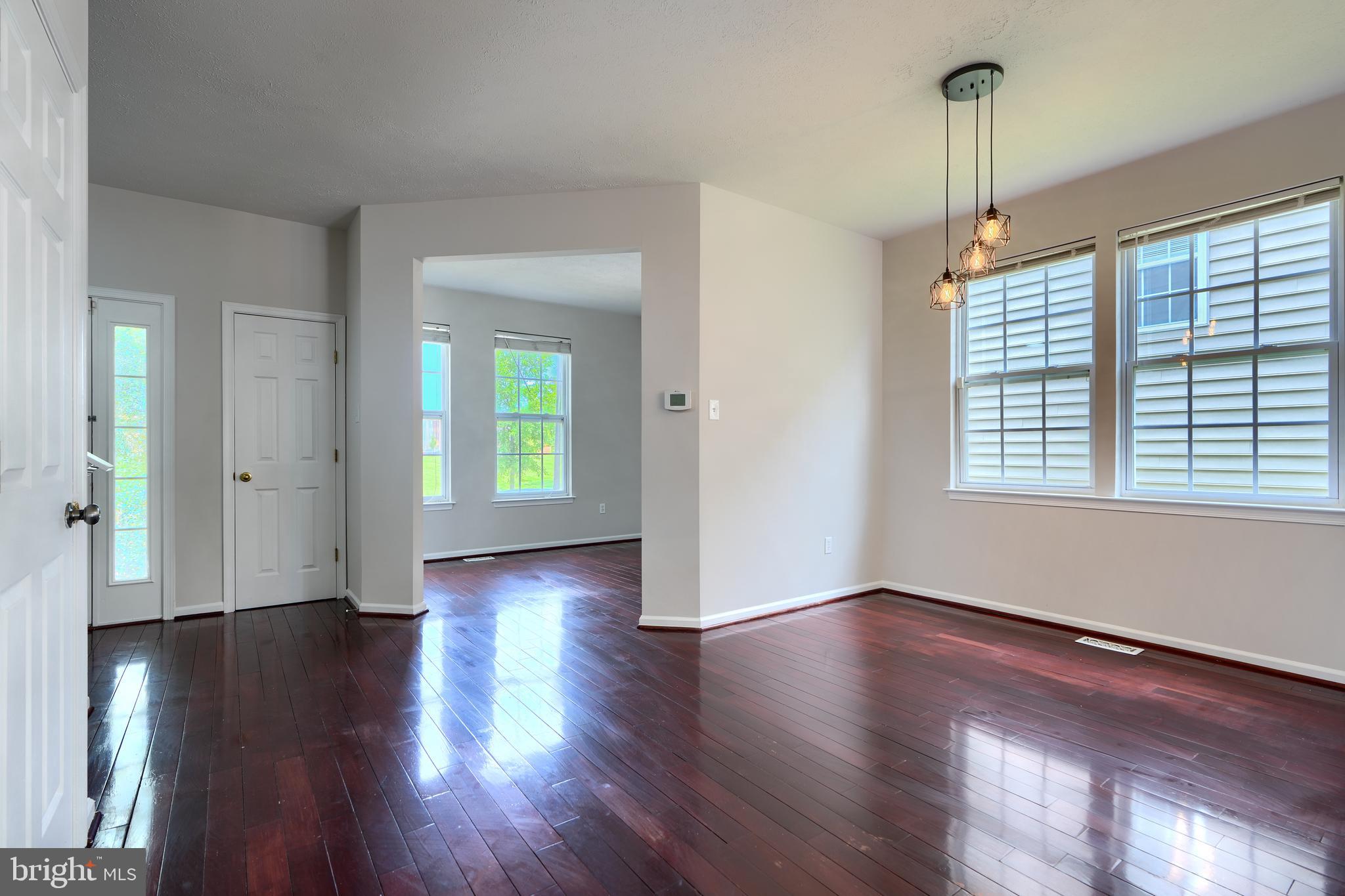 724 Tinker Road Middle River, MD 21220 - Photo 6 of 68 a view of an empty room with wooden floor and a window