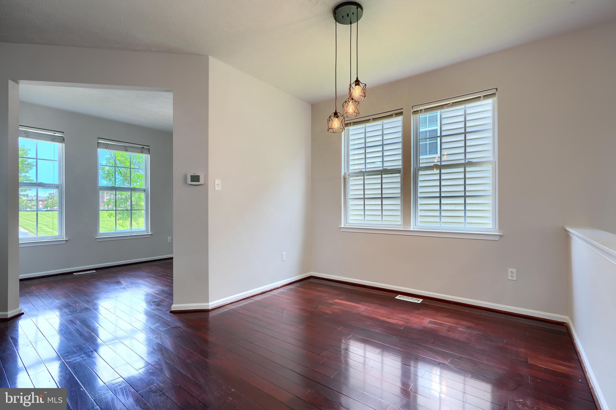 724 Tinker Road Middle River, MD 21220 - Photo 7 of 68 a view of an empty room with wooden floor and a window