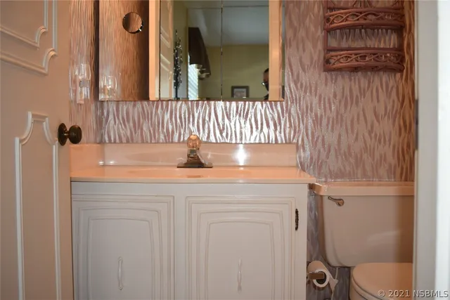 a bathroom with a sink toilet and mirror