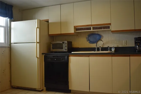 a kitchen with a refrigerator and a sink