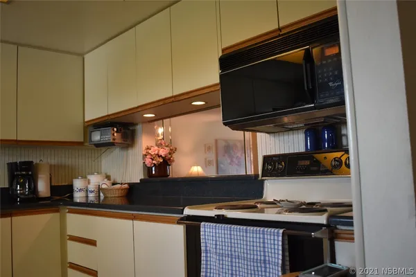 a kitchen with stainless steel appliances a stove and a microwave