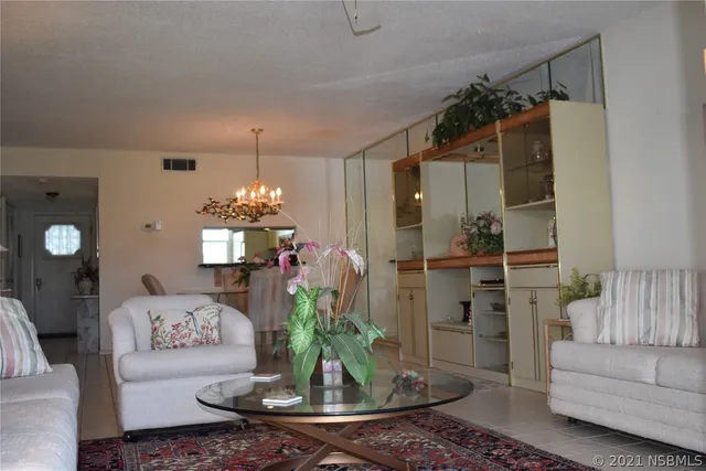 a living room with furniture and a chandelier