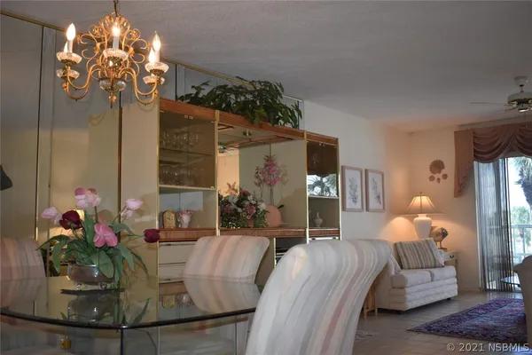 a living room with furniture chandelier and a chandelier