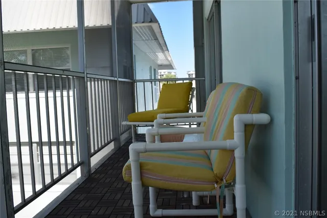 a view of balcony with furniture