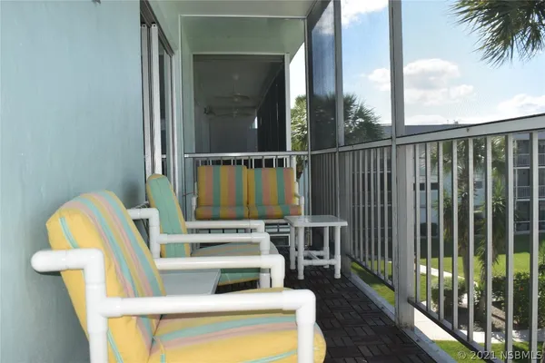 a view of balcony with furniture