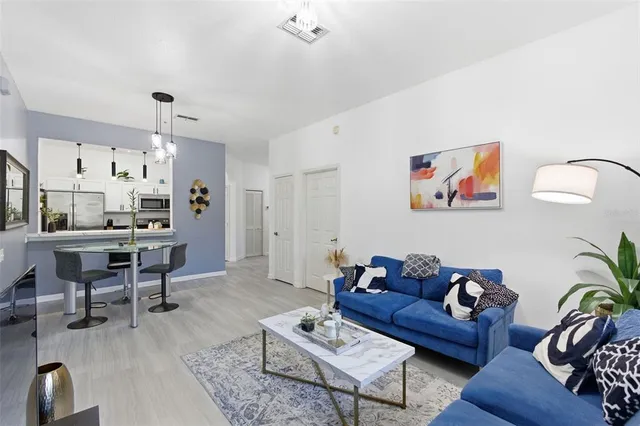 a kitchen with stainless steel appliances a stove microwave and sink
