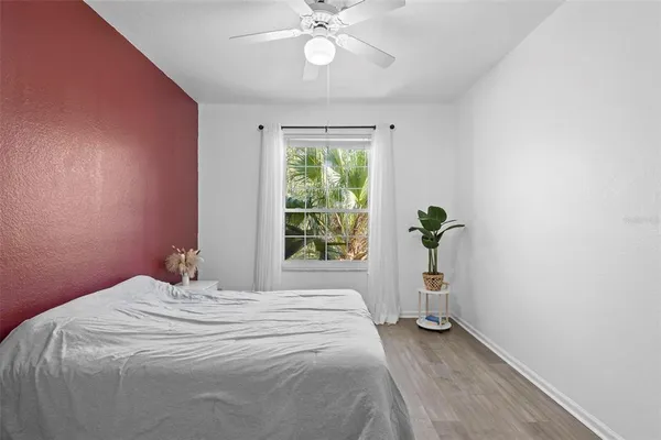 a bedroom with a bed and a chandelier