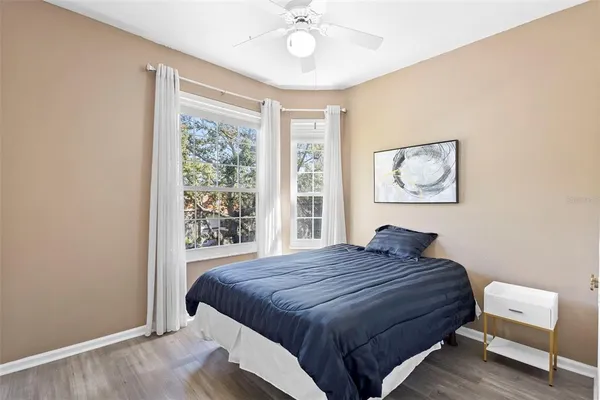 a bedroom with a large bed and a chandelier