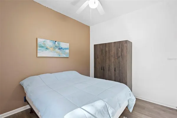 a bed room with a bed and a painting