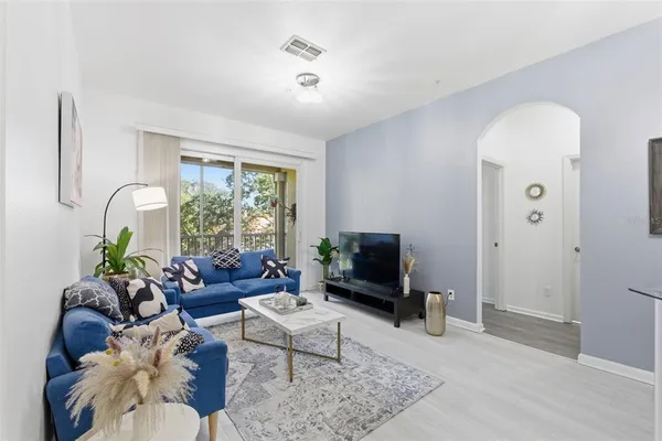 a living room with furniture and a flat screen tv