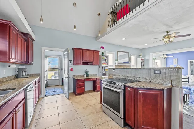 a kitchen with stainless steel appliances granite countertop a stove sink and cabinets