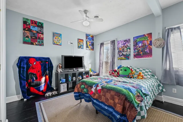 a bedroom with bed and wall painting on the wall