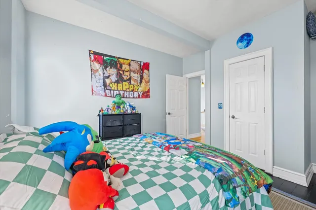 a bedroom with a bed and a dresser in it