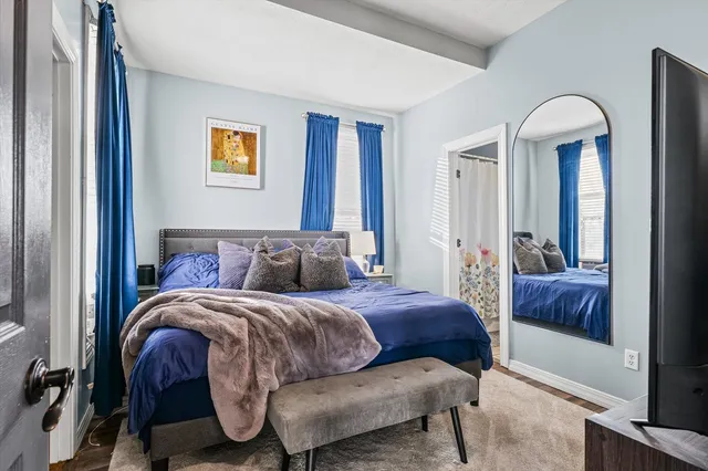 a bedroom with a bed and a mirror