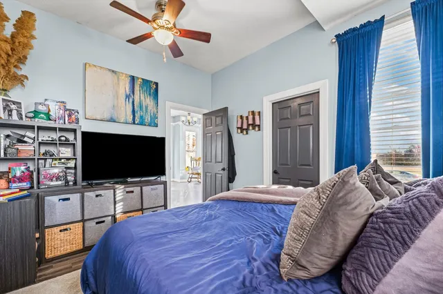 a bedroom with a bed and a flat screen tv