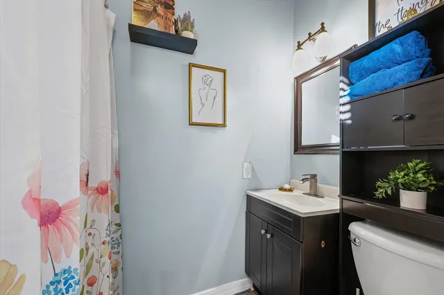 a bathroom with a sink toilet and vanity