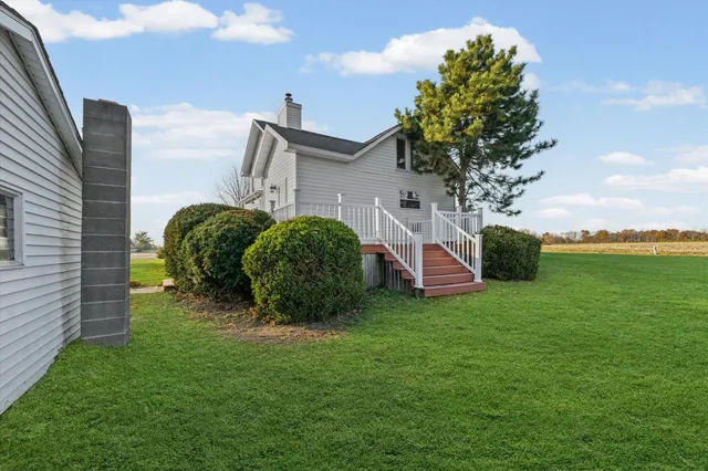 a view of a house with a backyard